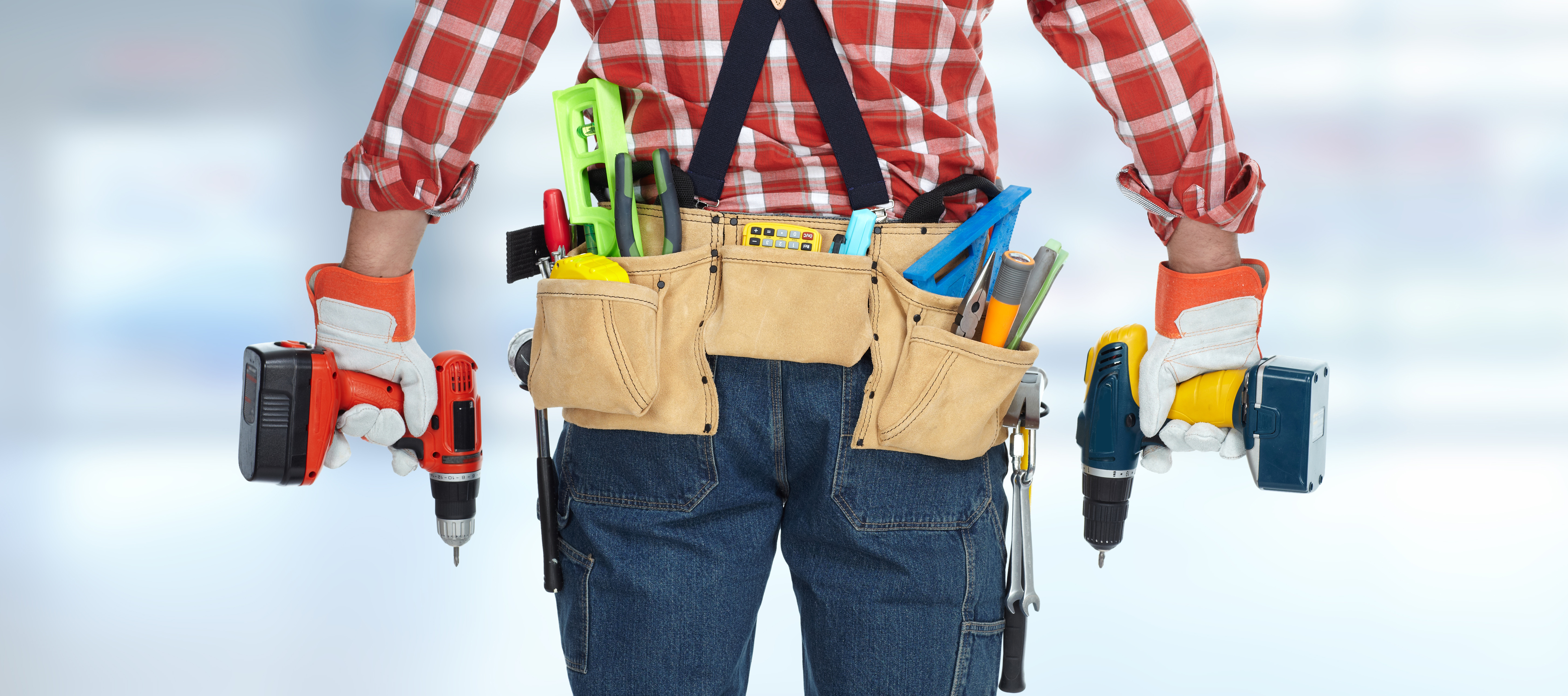 Technician repairing equipment with tools at a maintenance workstation